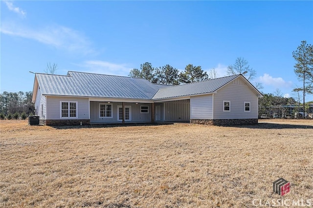 ranch-style home featuring central AC, a front yard, and french doors