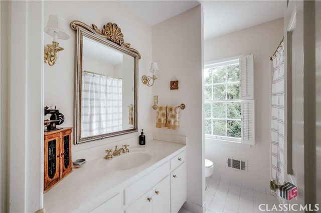 bathroom with vanity, tile patterned floors, and toilet