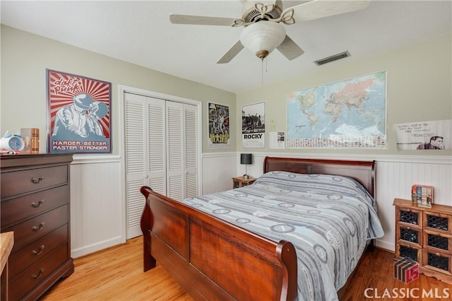 bedroom featuring a closet, ceiling fan, and light wood-type flooring