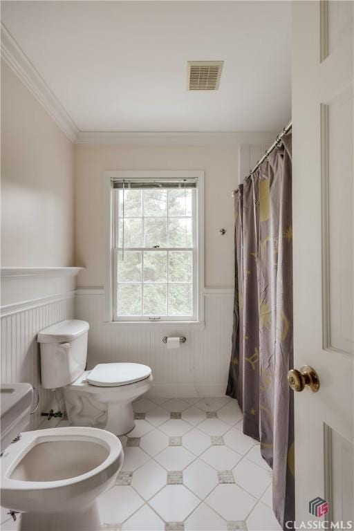 bathroom with ornamental molding, a bidet, and toilet