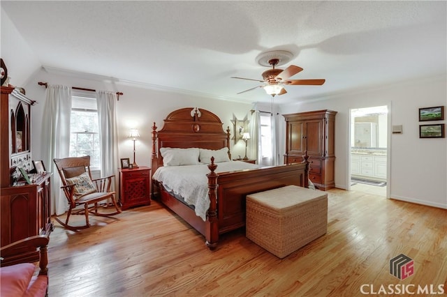 bedroom featuring crown molding, ceiling fan, light hardwood / wood-style floors, and ensuite bath