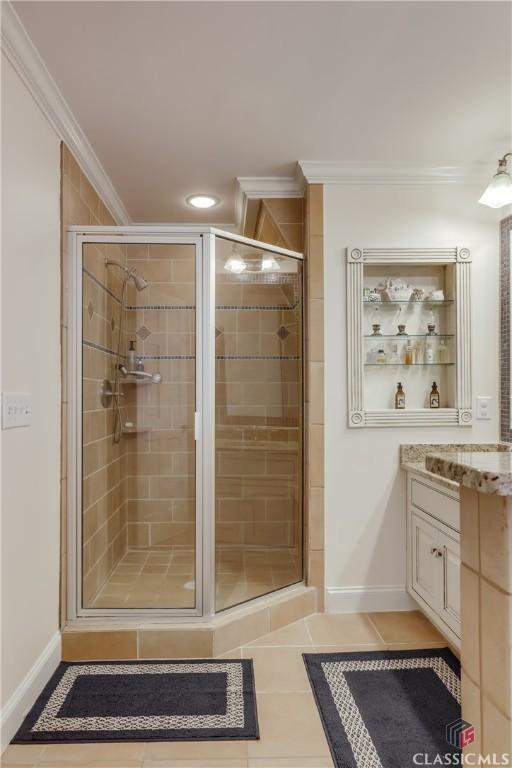 bathroom featuring crown molding, vanity, an enclosed shower, and tile patterned flooring