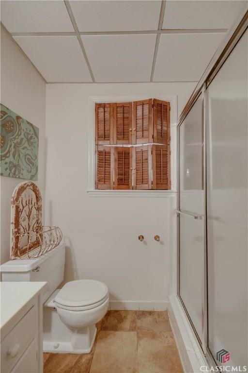 bathroom featuring vanity, a paneled ceiling, toilet, and walk in shower