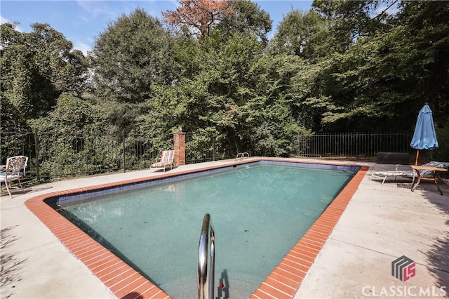 view of swimming pool with a patio