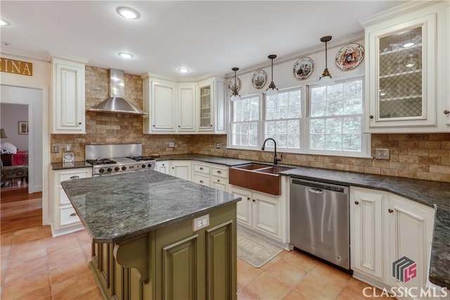 kitchen featuring wall chimney exhaust hood, range, decorative light fixtures, a center island, and stainless steel dishwasher