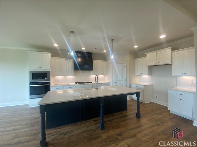 226 Montview Dr, Jefferson, GA 30549 - kitchen featuring crown molding, baseboards, white cabinets, an island with sink, and recessed lighting