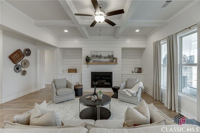 kitchen featuring white cabinets, light wood-type flooring, backsplash, light countertops, and appliances with stainless steel finishes