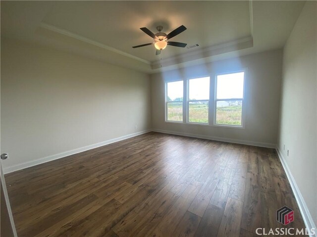 226 Montview Dr, Jefferson, GA 30549 - empty room featuring a raised ceiling, dark wood-style floors, ceiling fan, ornamental molding, and baseboards