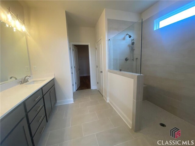 226 Montview Dr, Jefferson, GA 30549 - bathroom with a walk in shower, tile patterned flooring, baseboards, and vanity