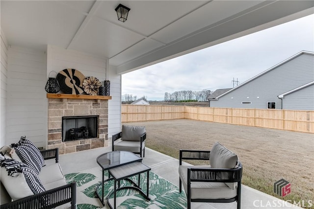 view of patio with an outdoor living space with a fireplace