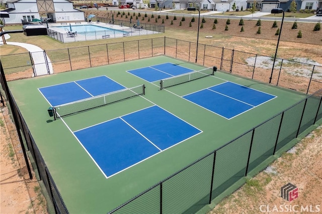 view of tennis court featuring a community pool and basketball court