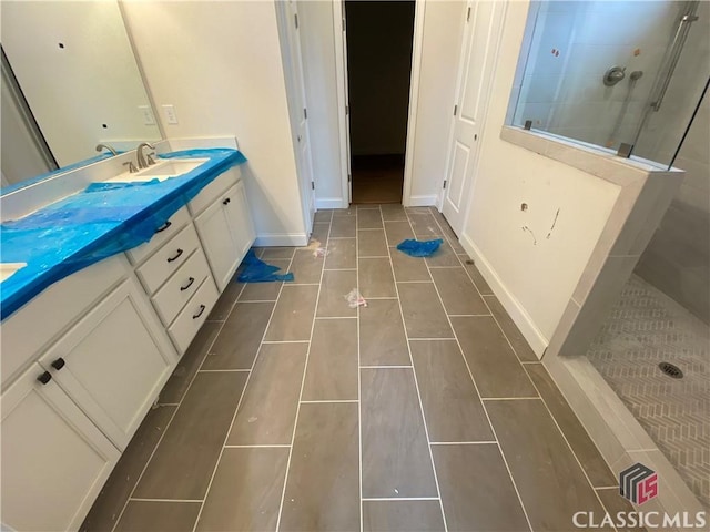 hall featuring baseboards, crown molding, and light wood finished floors