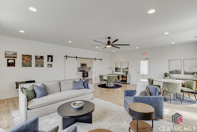 226 Montview Dr, Jefferson, GA 30549 - living area featuring a barn door, light wood-style flooring, recessed lighting, a ceiling fan, and baseboards