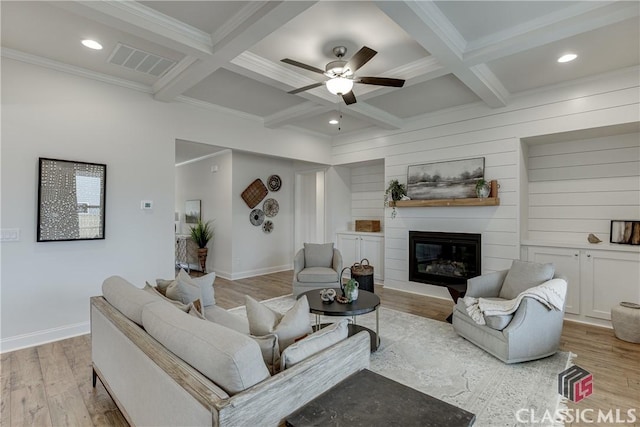 living room with coffered ceiling, beam ceiling, and light hardwood / wood-style flooring