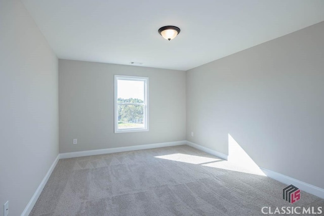 spare room with light colored carpet