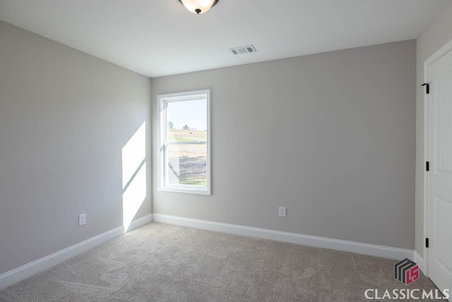 unfurnished room with light carpet