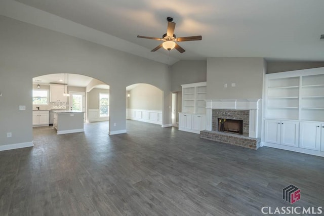 unfurnished living room with ceiling fan, dark hardwood / wood-style flooring, and vaulted ceiling