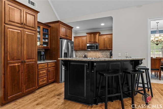 1750 Ryland Hills Dr, Watkinsville, GA 30677 - kitchen with tasteful backsplash, visible vents, a chandelier, stainless steel appliances, and a breakfast bar area