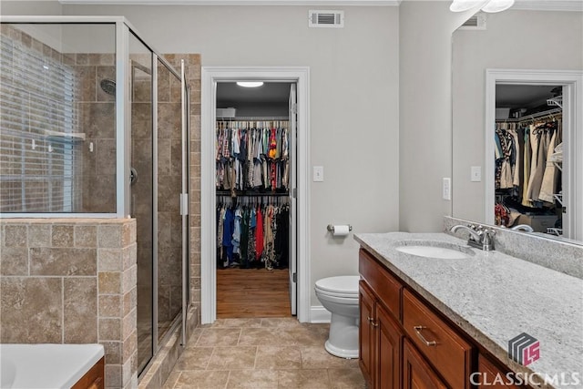 1750 Ryland Hills Dr, Watkinsville, GA 30677 - full bath featuring a walk in closet, a stall shower, vanity, and visible vents