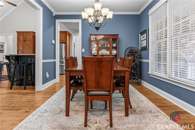 1750 Ryland Hills Dr, Watkinsville, GA 30677 - dining space featuring a notable chandelier, baseboards, crown molding, and wood finished floors