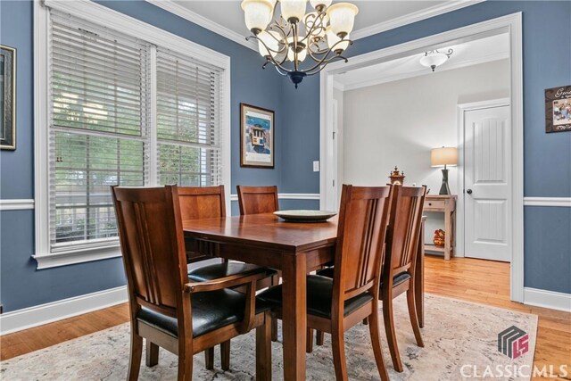 1750 Ryland Hills Dr, Watkinsville, GA 30677 - dining space featuring crown molding, a notable chandelier, baseboards, and light wood-type flooring