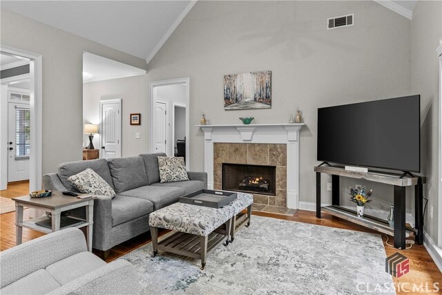 1750 Ryland Hills Dr, Watkinsville, GA 30677 - living room with a tile fireplace, wood finished floors, lofted ceiling, and visible vents