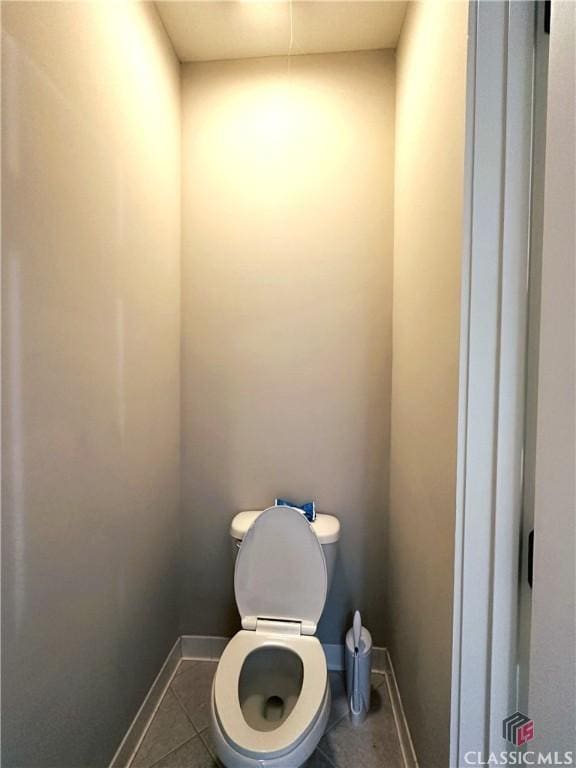 bathroom with tile patterned floors and toilet