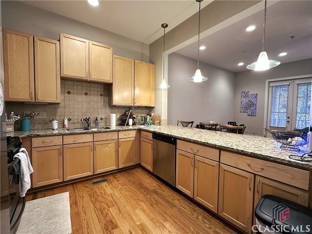 kitchen featuring pendant lighting, backsplash, light hardwood / wood-style floors, and dishwasher