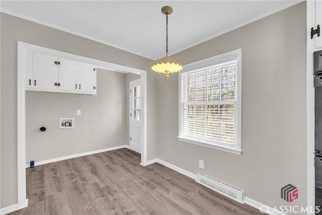 laundry room featuring cabinets, hookup for a washing machine, light hardwood / wood-style flooring, and electric dryer hookup