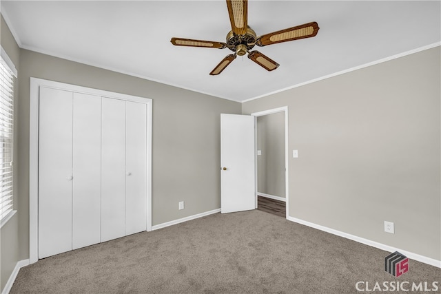 unfurnished bedroom featuring crown molding, carpet floors, a closet, and ceiling fan