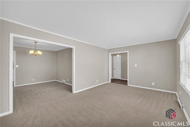 unfurnished room with crown molding, carpet floors, and a notable chandelier