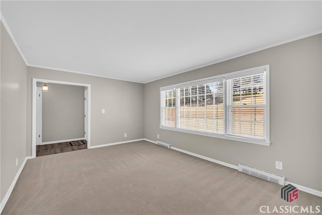 empty room with crown molding and carpet