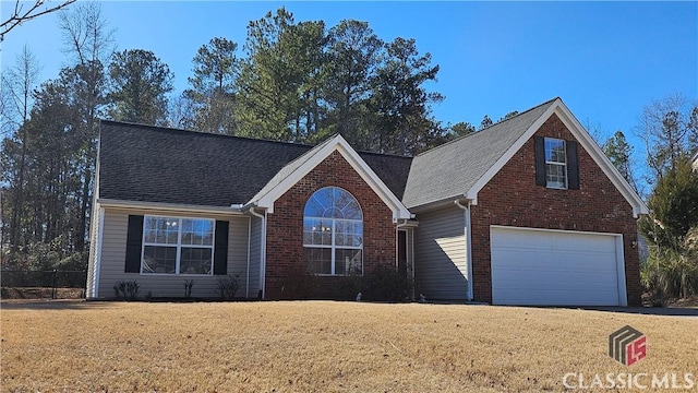 front facade with a garage and a front lawn