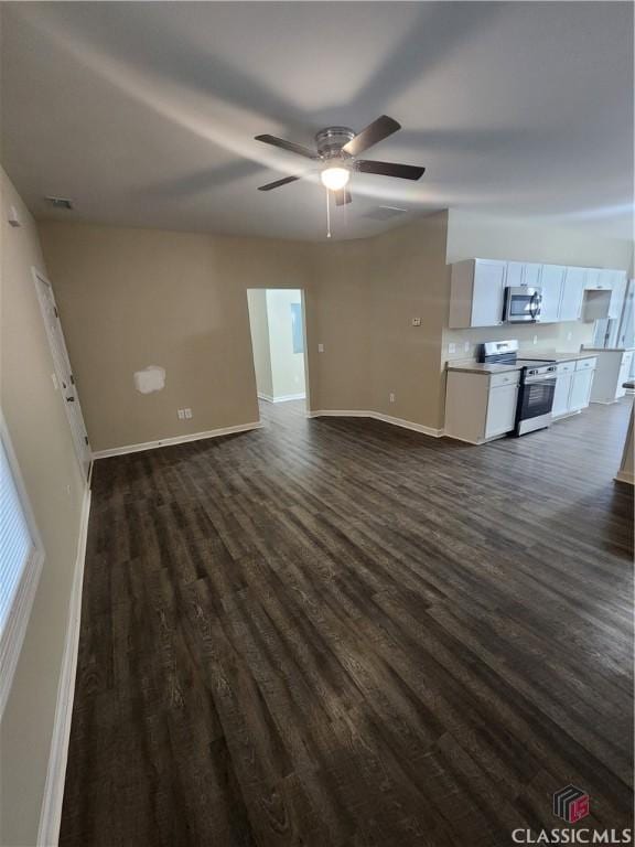 unfurnished living room with ceiling fan and dark hardwood / wood-style flooring