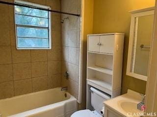 full bathroom featuring vanity, toilet, and tiled shower / bath combo