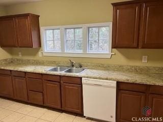 kitchen featuring dishwasher, sink, light tile patterned flooring, and light stone counters