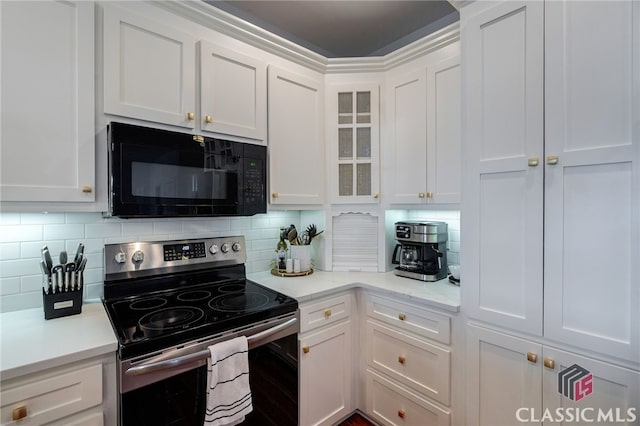 kitchen with tasteful backsplash, stainless steel electric stove, and white cabinets