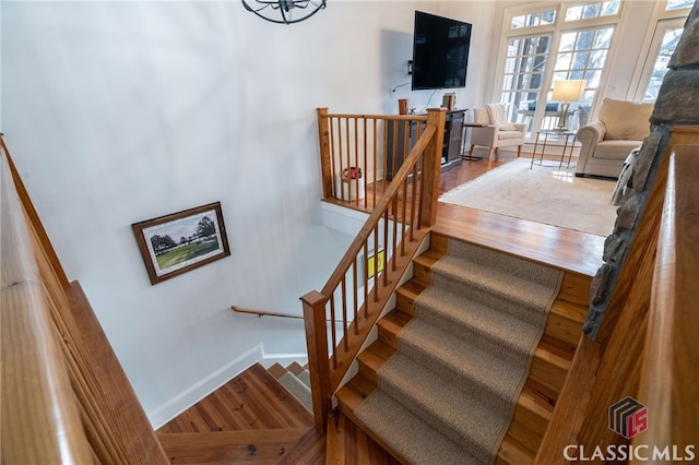 stairway with hardwood / wood-style flooring