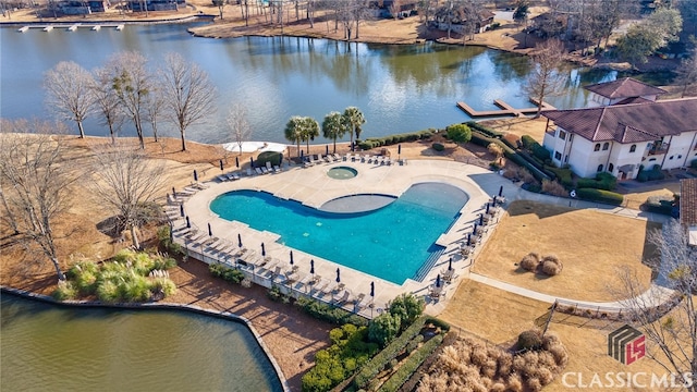 view of swimming pool featuring a water view