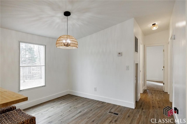 unfurnished dining area featuring light wood-type flooring