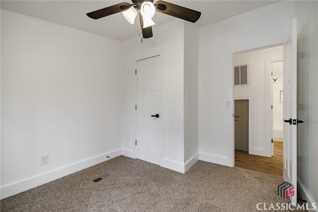 unfurnished bedroom featuring ceiling fan and carpet