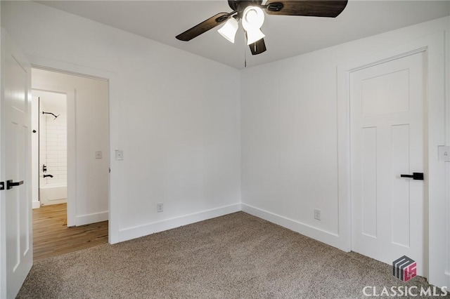 spare room featuring ceiling fan and carpet flooring