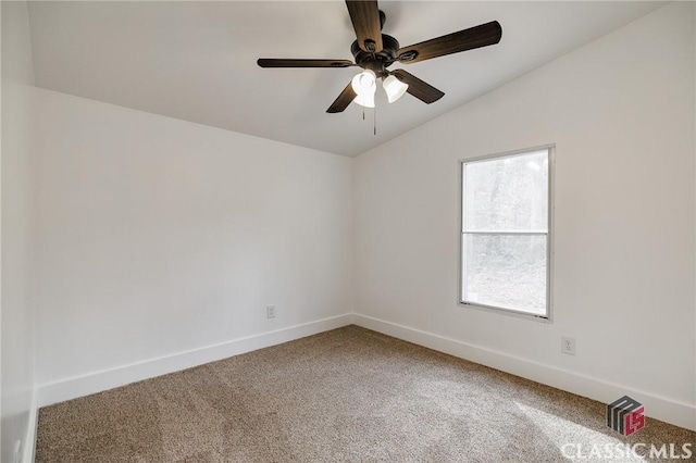 carpeted empty room with ceiling fan and vaulted ceiling