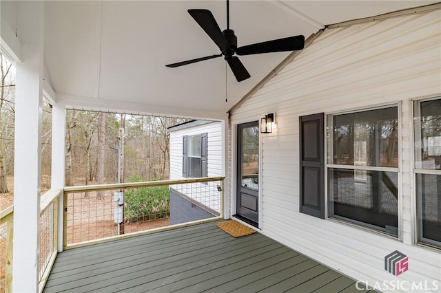 wooden deck featuring ceiling fan