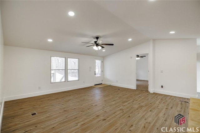 interior space featuring ceiling fan, lofted ceiling, and light wood-type flooring