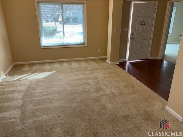 foyer featuring light colored carpet