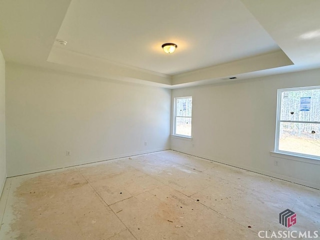 empty room featuring visible vents and a tray ceiling