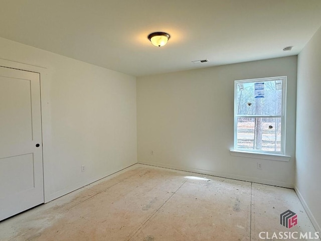 spare room featuring visible vents and baseboards