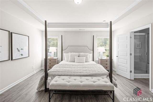 bedroom featuring multiple windows, light wood-type flooring, and baseboards