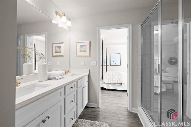 full bath featuring a shower stall, double vanity, and a sink